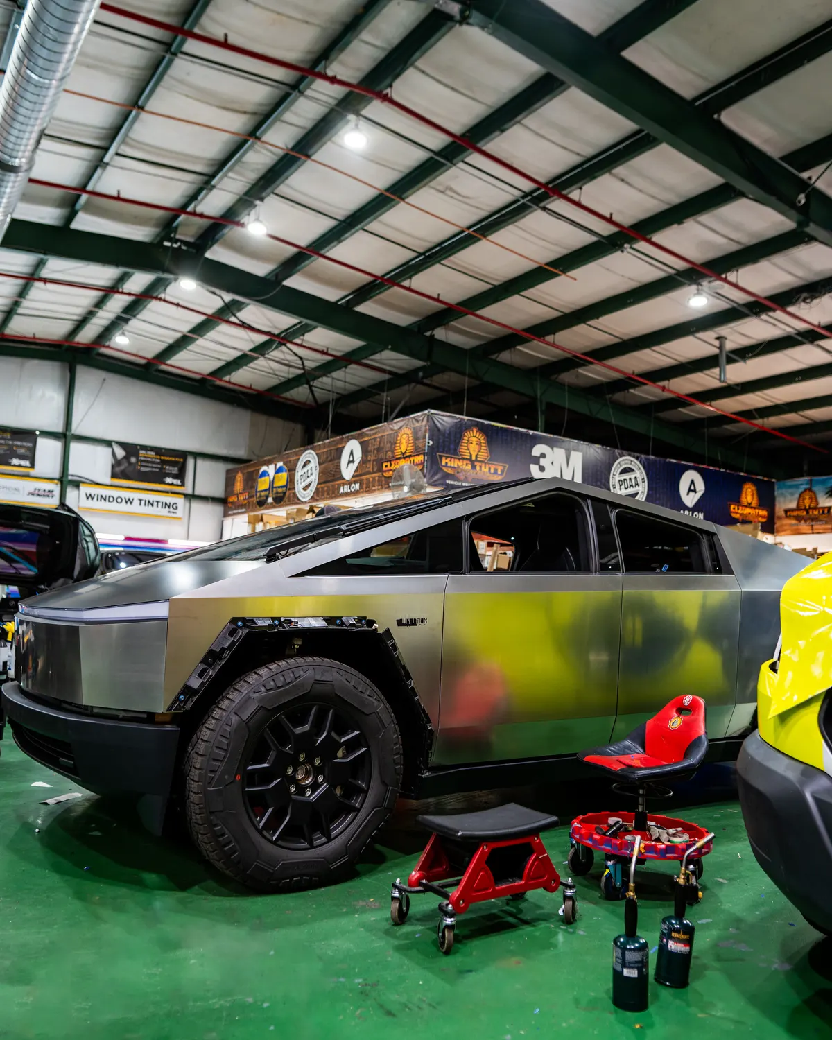 Cybertruck mid-wrap inside the King Tutt Graphics shop